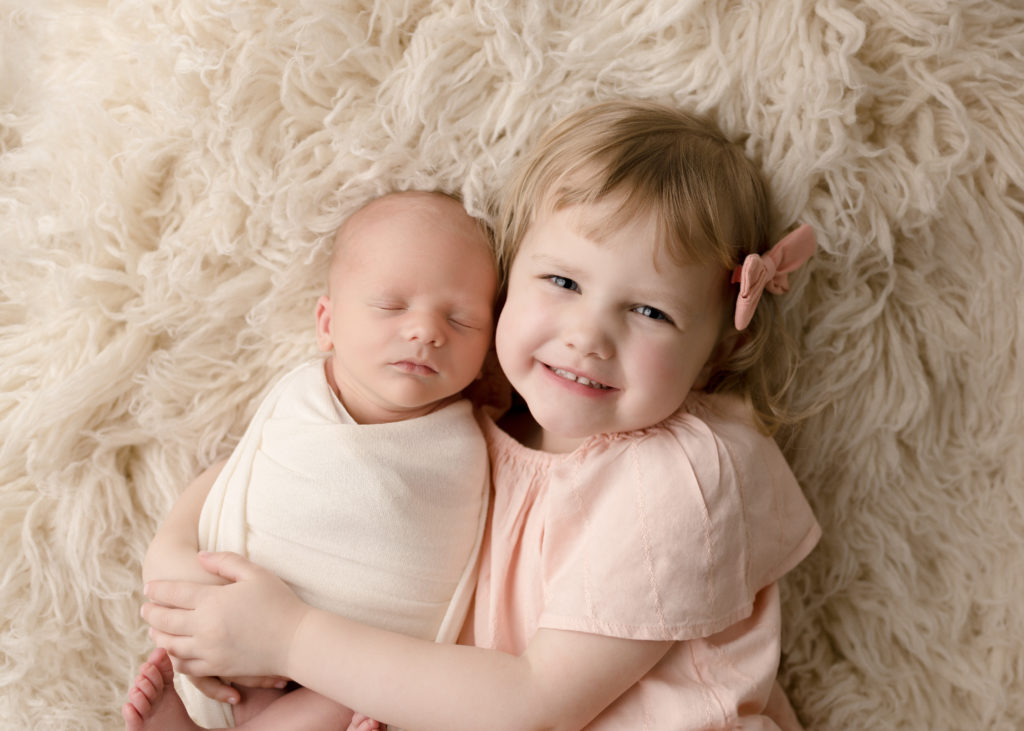 Gulf Breeze, FL Newborn Photographer, big sister holding newborn baby brother