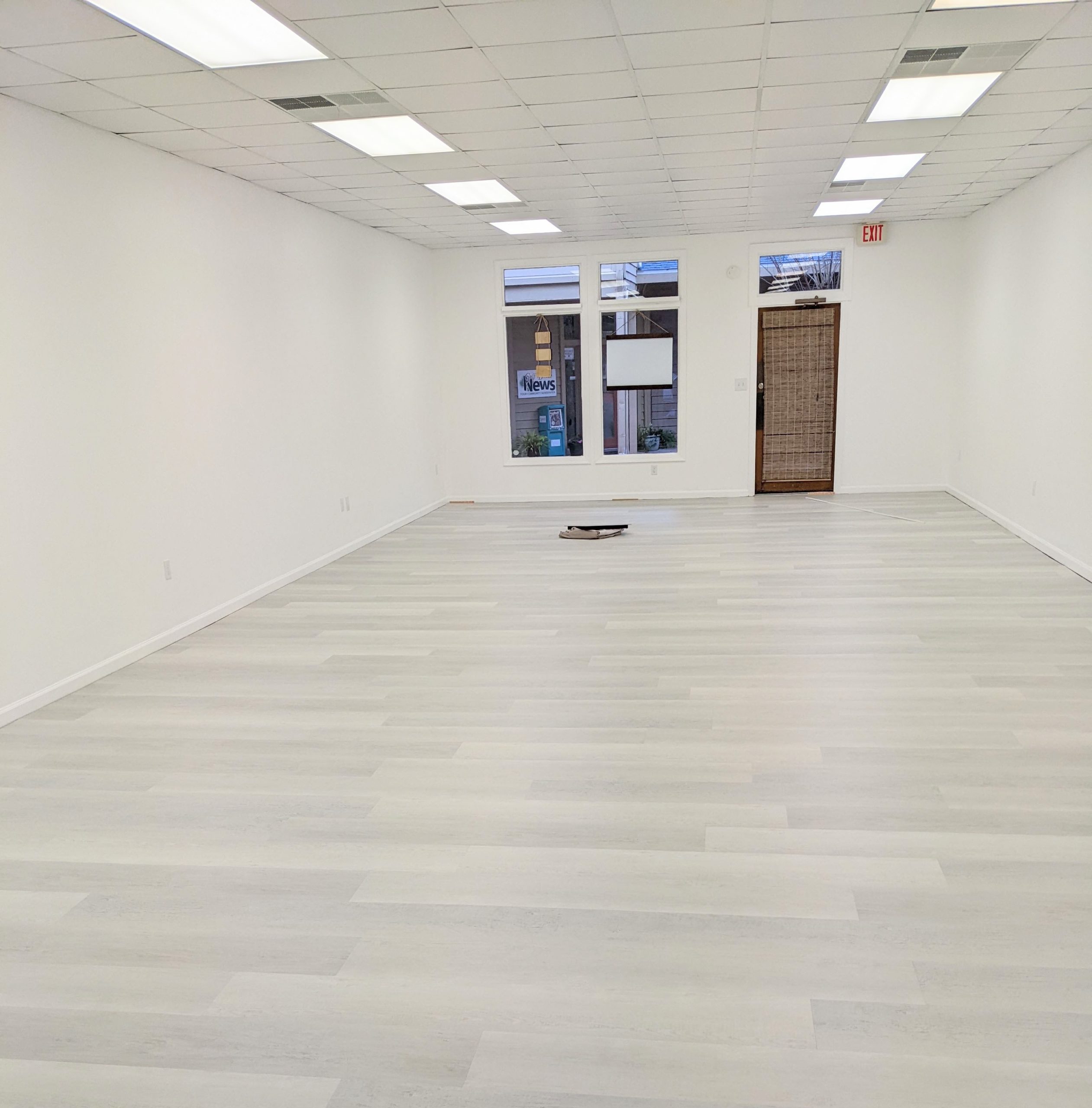 newly renovated photography studio with fresh white paint and white plank floors.