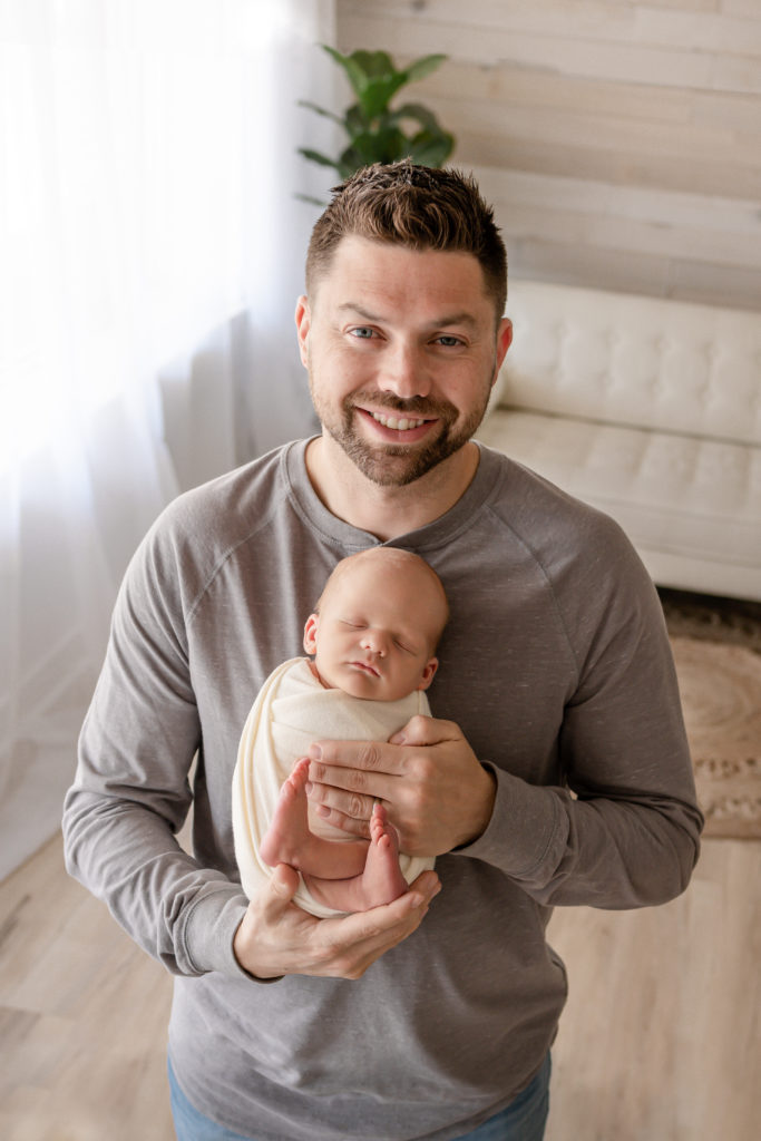Pensacola, FL Newborn Photographer New Dad Holding Baby
