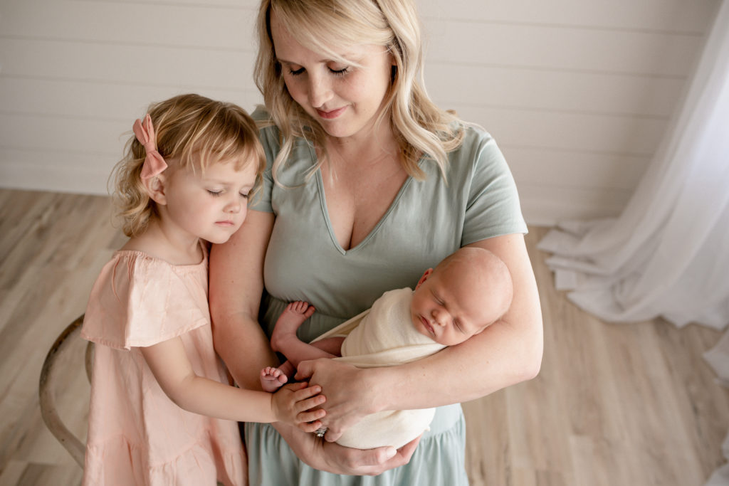 Milton, FL Newborn Photographer Mother Holding Baby and Toddler