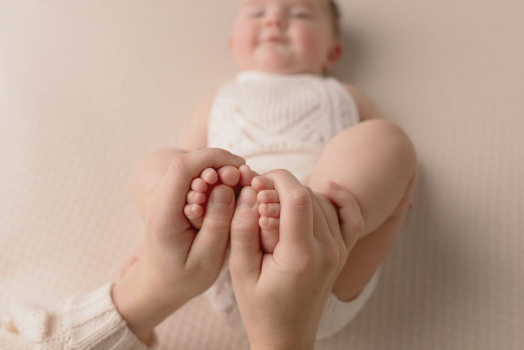 Image of parent holding baby's toes