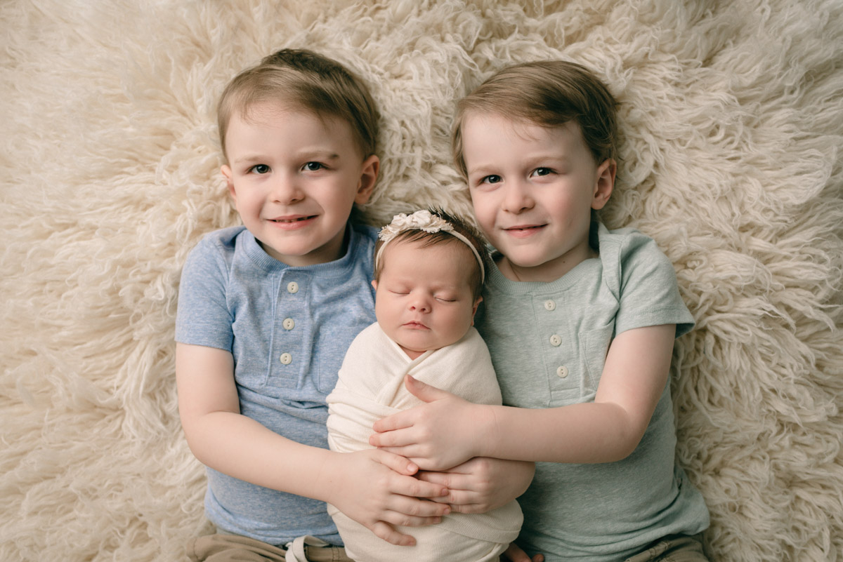 Pensacola,FL Newborn Photographer. Siblings posing with newborn sister